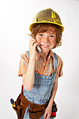 Little Boy Dressed Up as Construction Worker Talking on Cell Phone