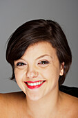 Head and Shoulders Portrait of Mid-Adult Woman with Grey Background