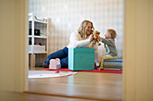 Mother playing with baby with down syndrome