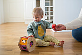 Mother and toddler with down syndrome playing