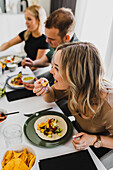 Group of friends eating Mexican food at home