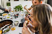 Group of friends eating Mexican food at home