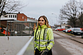 Portrait of young female road worker