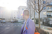 Side view of short-haired woman looking at street