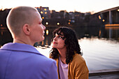 Young woman looking away, river in background