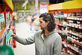 Side view of man doing shopping in supermarket