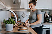 Pregnant woman making breakfast at home