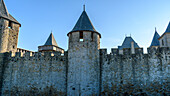 The Château Comtal, Count’s Castle, is a medieval castle in the Cité of Carcassonne, tall towers and wall.