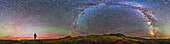 A 360° panorama of the landscape and skyscape at Grasslands National Park, Saskatchewan, Canada, taken August 25, 2014. The Milky Way arches overhead from south to north at right, and the last vestiges of twilight light the western sky at left, providing a natural backdrop for the silhouette of the photographer gazing wistfully into the distance! Some green bands of airglow also light the sky, but only a few farm lights from outside the boundaries of the Park mar the landscape in this darkest of Dark Sky Preserves in Canada. I shot this from the Eagle Butte Loop Trail at the end of the 70 Mile