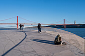 People on MAAT (Museum of Art, Architecture and Technology) roof, designed by the British architect Amanda Levete. View of Ponte 25 de Abril bridge. Belem, Lisbon, Portugal