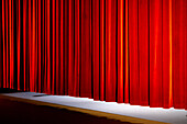 The curtain going down at the end of a play in a theatre hall