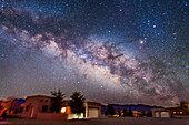 The summer Milky Way and centre of the Galaxy area in Scorpius and Sagittarius rising above the adobe lodges at the Painted Pony Resort in southwest New Mexico, March 14, 2013. This is a stack of 5 x 3.5 minute exposures at f/2.8 with the 24mm lens and Canon 5D MkII at ISO 1600, plus a layer of two exposures taken through the Softon filter for the star glows.