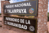 Park sign for Talampaya National Park, La Rioja Province, Argentina. Behind is the Sierra de Sanogasta mountain range.