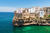 Polignano a mare, the medieval and white sea town facing the turquoise water of the Adriatic Sea, day time, Bari, Apulia, Mediterranean Sea, Italy, Europe