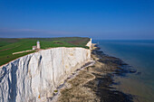 View from drone of Belle Tout lighthouse at low tide, Seven Sisters chalk cliffs, South Downs National Park, East Sussex, England, United Kingdom, Europe