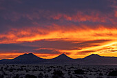 USA, New Mexico, Santa Fe, Dramatic sunset sky over Cerrillos Hills State Park desert landscape