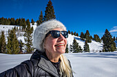 Lächelnde ältere Frau beim Entspannen in den Bergen