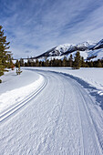 USA, Idaho, Sun Valley, Schneebedeckte Berge mit unbefestigter Straße