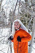 Smiling woman snowshoeing in winter 