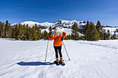 USA, Idaho, Ketchum, Back view of woman snowshoeing in mountains