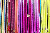 Multi-colored dog leashes hanging in row