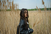 Portrait of teenage girl (16-17) standing in field 