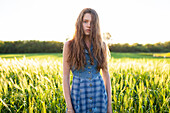 Portrait of woman standing in field