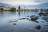Rocks in Vltava river near Charles Bridge at twilight, Prague, Czech Republic (Czechia), Europe