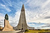 The spire of Hallgrimskirkja Church, fronted by a statue of Leifur Eriksson, founder of Iceland, in central Reykjavik, Iceland, Polar Regions