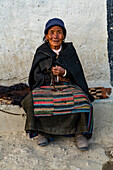 Old woman with a prayer wheel in her hand, Lo Manthang, Kingdom of Mustang, Nepal, Asia