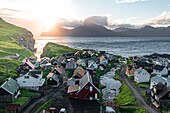 Luftaufnahme des Küstendorfes Gjogv und der Insel Kalsoy in der Morgendämmerung, Insel Eysturoy, Färöer Inseln, Dänemark, Europa