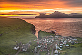 Fiery sky at dawn over Kalsoy island and the village of Gjogv, overhead view, Eysturoy Island, Faroe Islands, Denmark, Europe