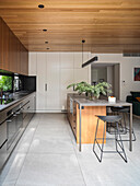 Open kitchen with kitchen island and floor-to-ceiling built-in cabinets