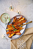 Roasted parsnips and carrots with maple syrup glaze served with hummus mayonnaise with Thai basil