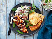 Tandoori chicken with naan and tomato and cucumber salad