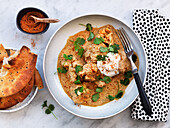 Indian vegetable curry with cauliflower and cilantro, served with naan