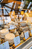 Cheeses on display at a market in Brittany