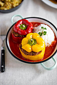 Vegan stuffed peppers with tomato sauce and rice