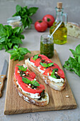 Sandwiches with homemade bread, cheese, tomato, and pesto