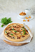 Quiche with chanterelles and onions in sour cream filling with cheese