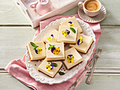 Lemon cheesecake squares with edible flowers