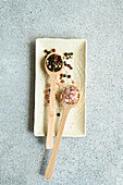Wooden spoon with pepper mixture and Himalayan salt