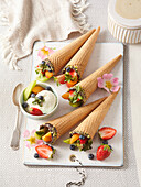 Ice cream cones with frozen yogurt and fruit