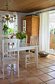 Country-style dining area with wooden furniture and terracotta flooring