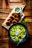 Braised cucumber ragout with potato pancakes and sour cream