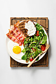 Fried egg, bacon, fresh salad and grilled bread
