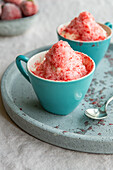 Grated frozen strawberries on whipped cream