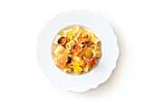 Pasta with yellow tomatoes, edible flowers, and anchovies