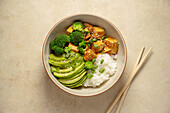Tofu rice bowl with avocado and broccoli