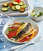 Grilled brown trout with peppers and zucchini